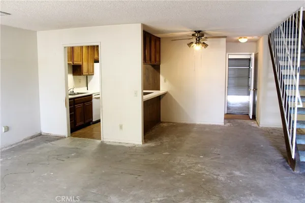 an empty room with a fireplace and entryway