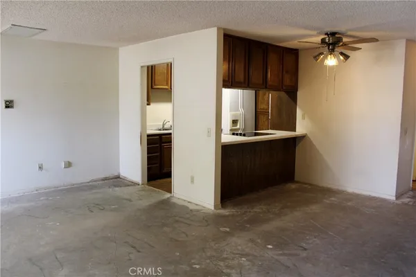 an empty room with closet and windows