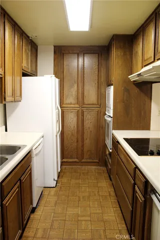 a kitchen with a refrigerator sink stove and cabinets