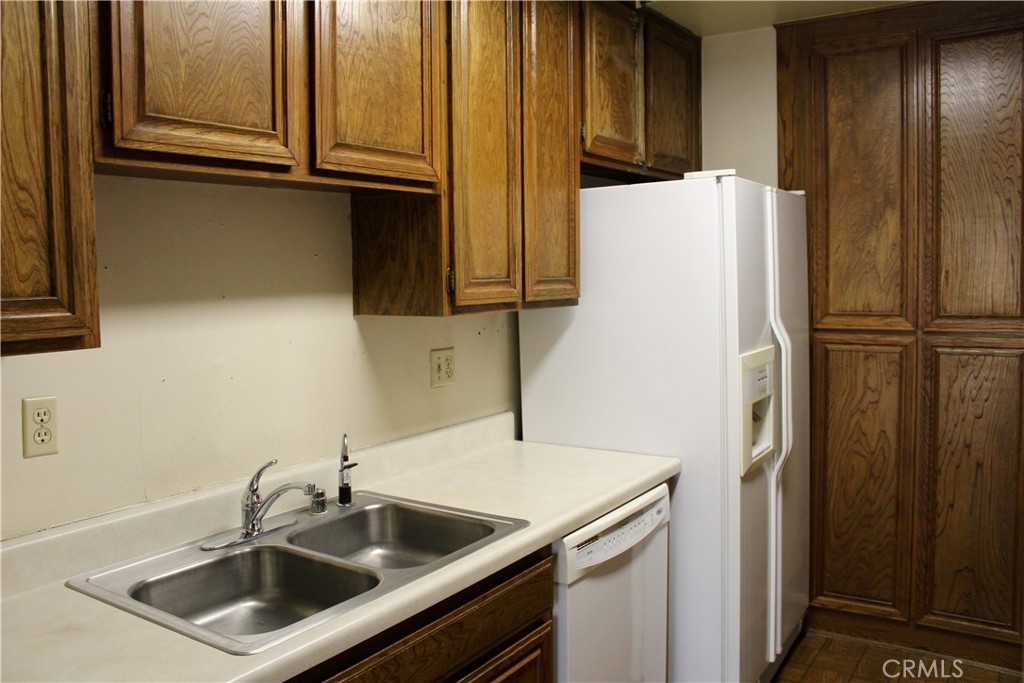 828 East Boone Street, Unit 12 Santa Maria, CA 93454 - Photo 9 of 32 a kitchen with stainless steel appliances granite countertop a refrigerator and a sink