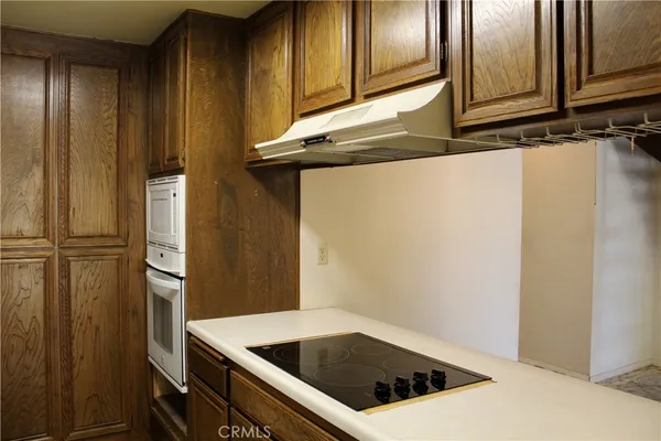 a kitchen with a refrigerator and cabinets