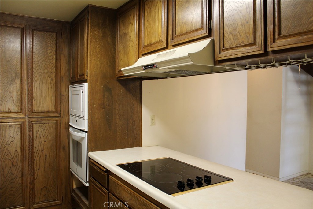 828 East Boone Street, Unit 12 Santa Maria, CA 93454 - Photo 10 of 32 a kitchen with a refrigerator and cabinets