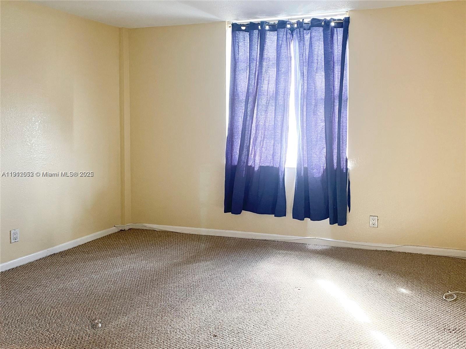430 Golden Isles Drive, Unit 701 Hallandale Beach, FL 33009 - Photo 7 of 11 an empty room with a window