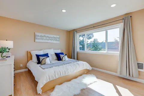 a bedroom with a large bed and a window