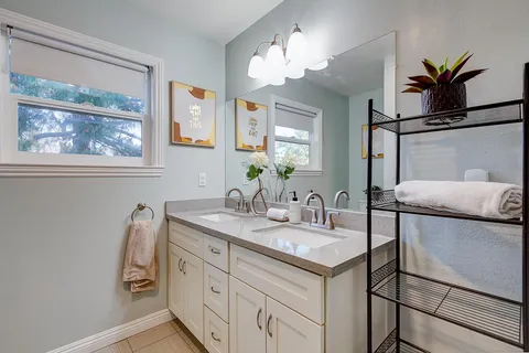a bathroom with a granite countertop sink mirror and vanity