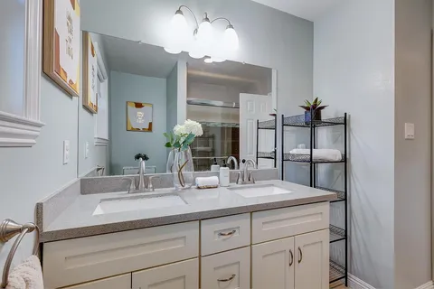 a bathroom with a sink double vanity and a mirror