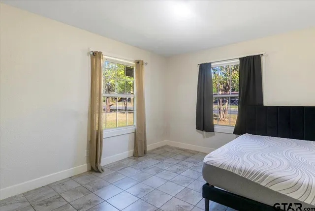 a spacious bedroom with a bed and a window