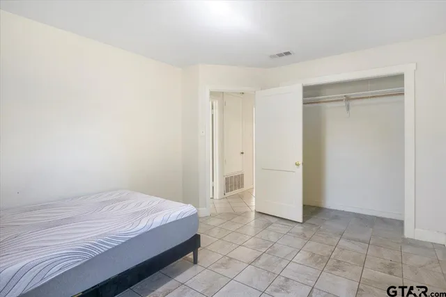 a spacious bedroom with a bed and a shower