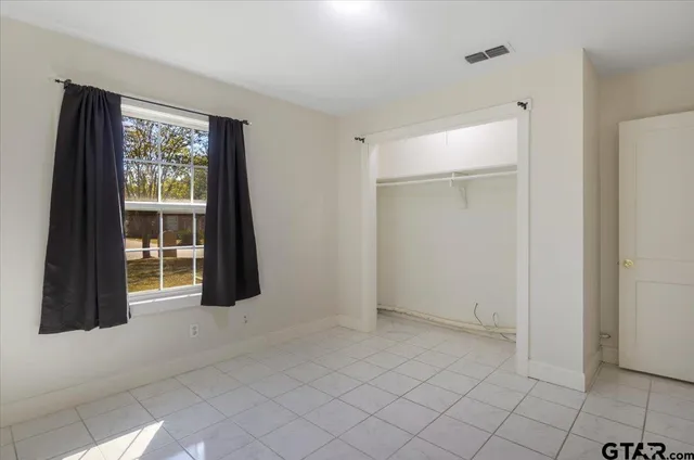 a view of a big room with windows and closet