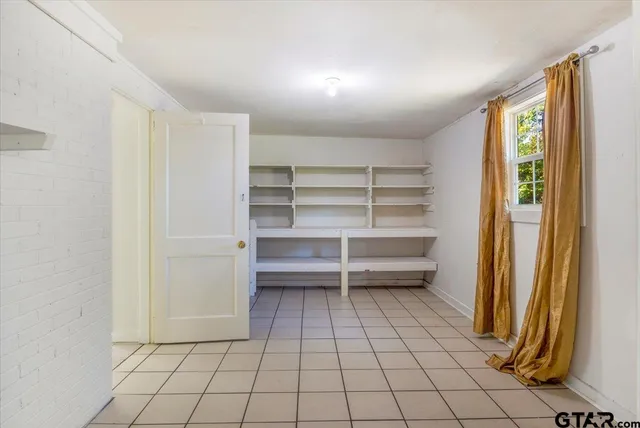 a room with washing machine and cabinets