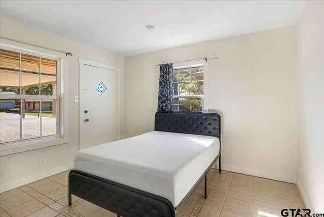 a bedroom with a bed and a window