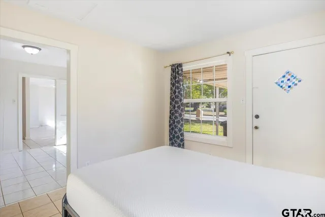 a bedroom with a bed and a window