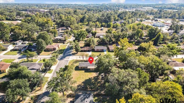 an aerial view of a houses with a yard