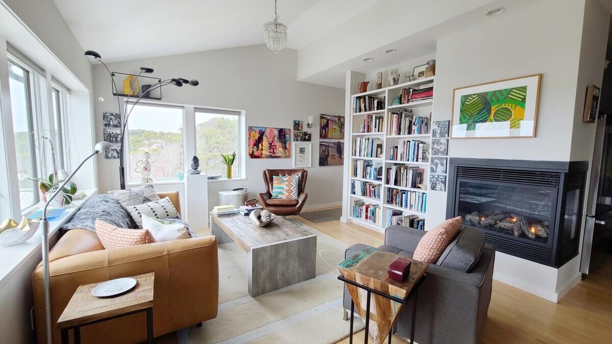 75 Richman Lane Wellfleet, MA 02667 - Photo 14 of 72 a living room with furniture a bookshelf and a window