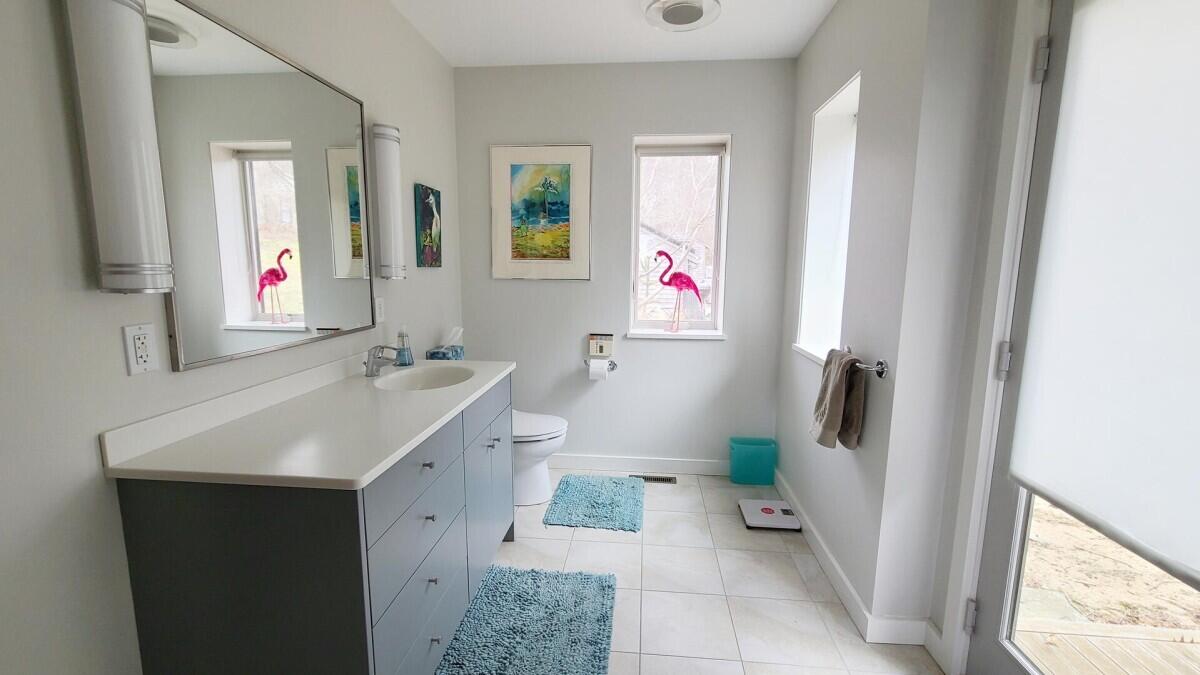75 Richman Lane Wellfleet, MA 02667 - Photo 21 of 72 a bathroom with a sink toilet and a mirror