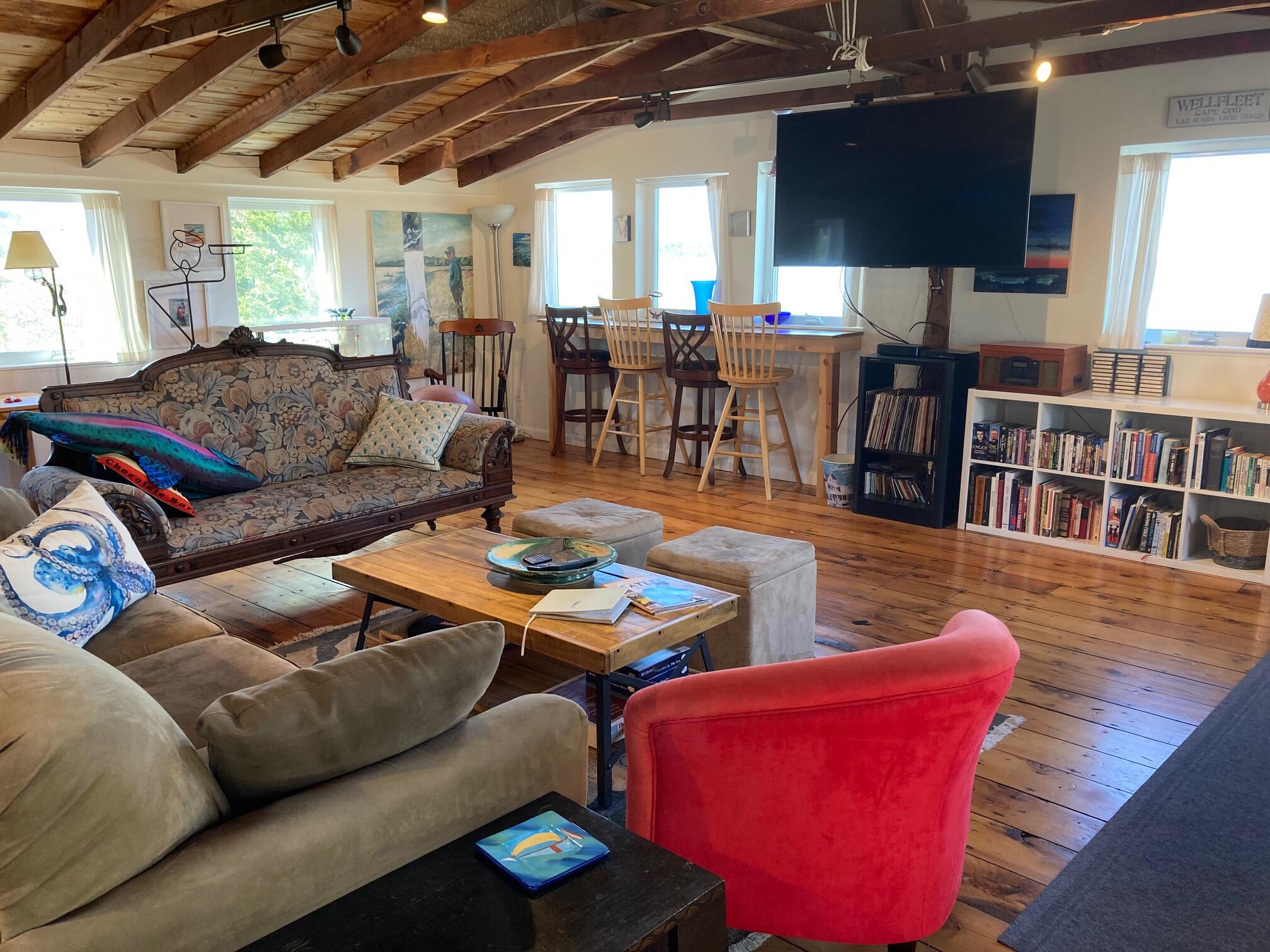 75 Richman Lane Wellfleet, MA 02667 - Photo 49 of 72 a living room with furniture kitchen view and a large window
