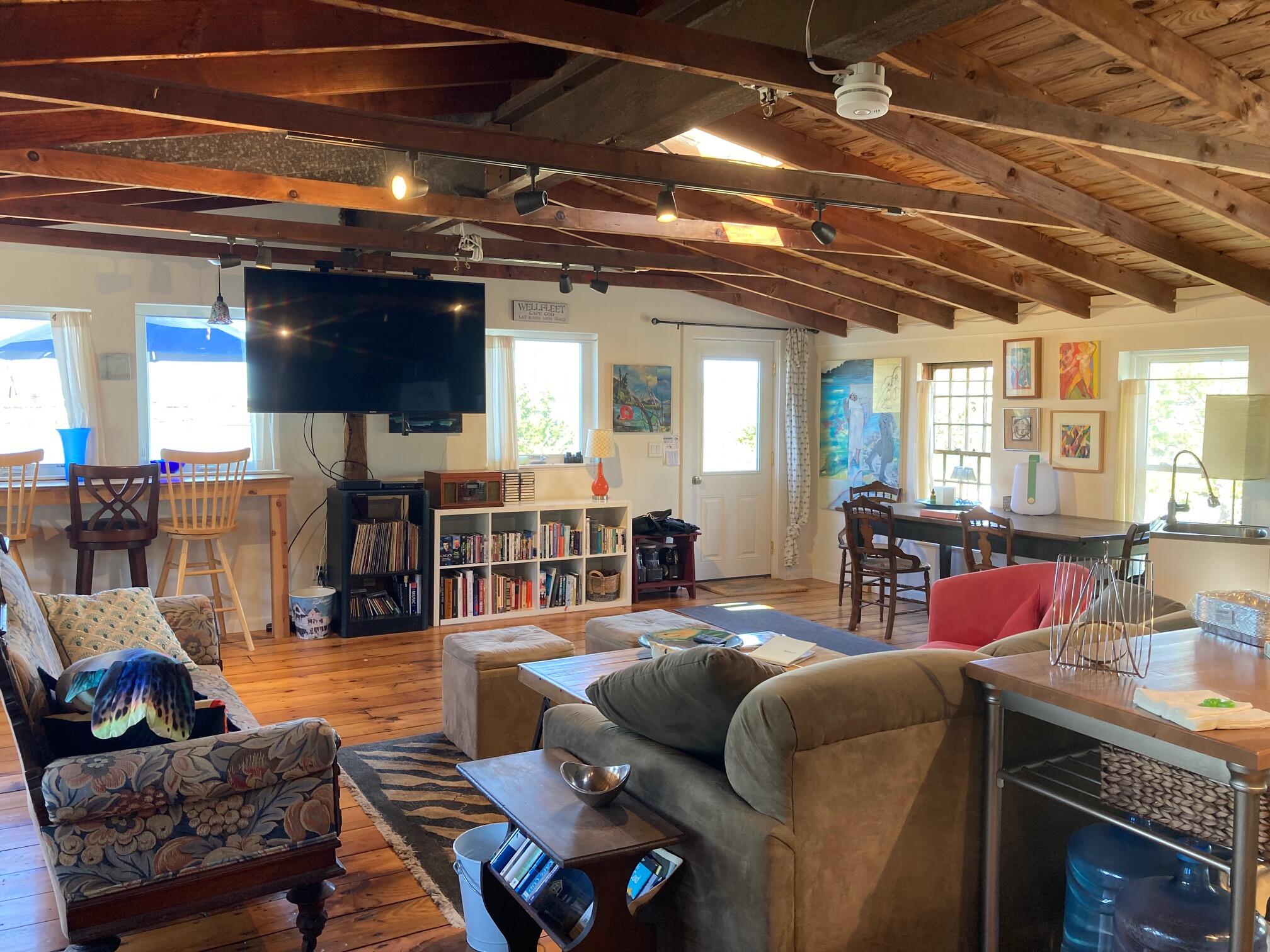 75 Richman Lane Wellfleet, MA 02667 - Photo 50 of 72 a living room with furniture and a chandelier