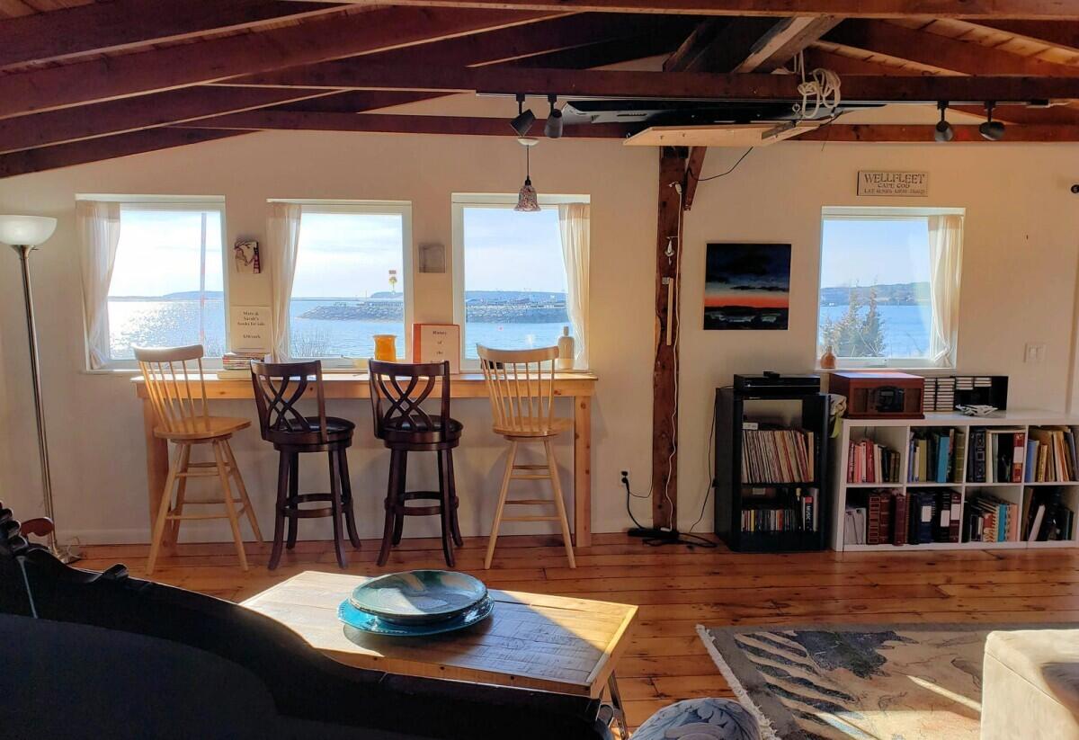 75 Richman Lane Wellfleet, MA 02667 - Photo 52 of 72 a living room with furniture and a book shelf