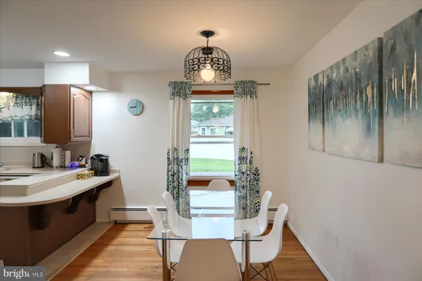 a dining room with furniture and window
