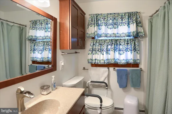 a bathroom with a sink mirror and toilet