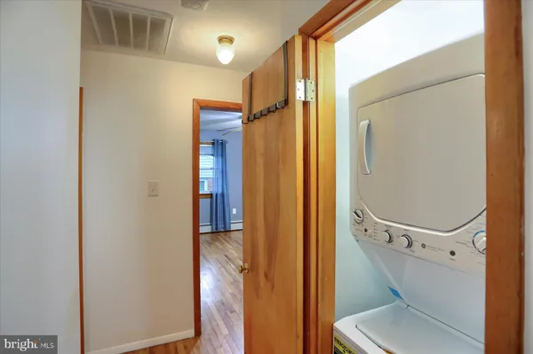 a bathroom with a mirror a toilet and a glass door