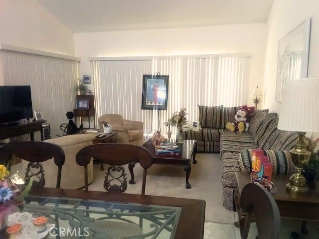 200 East Racquet Club Road, Unit 19 Palm Springs, CA 92262 - Photo 4 of 21 a living room with furniture and a flat screen tv
