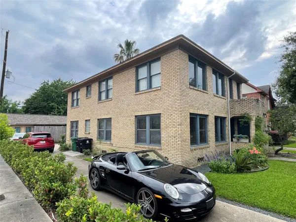 a front view of house with yard and car parked