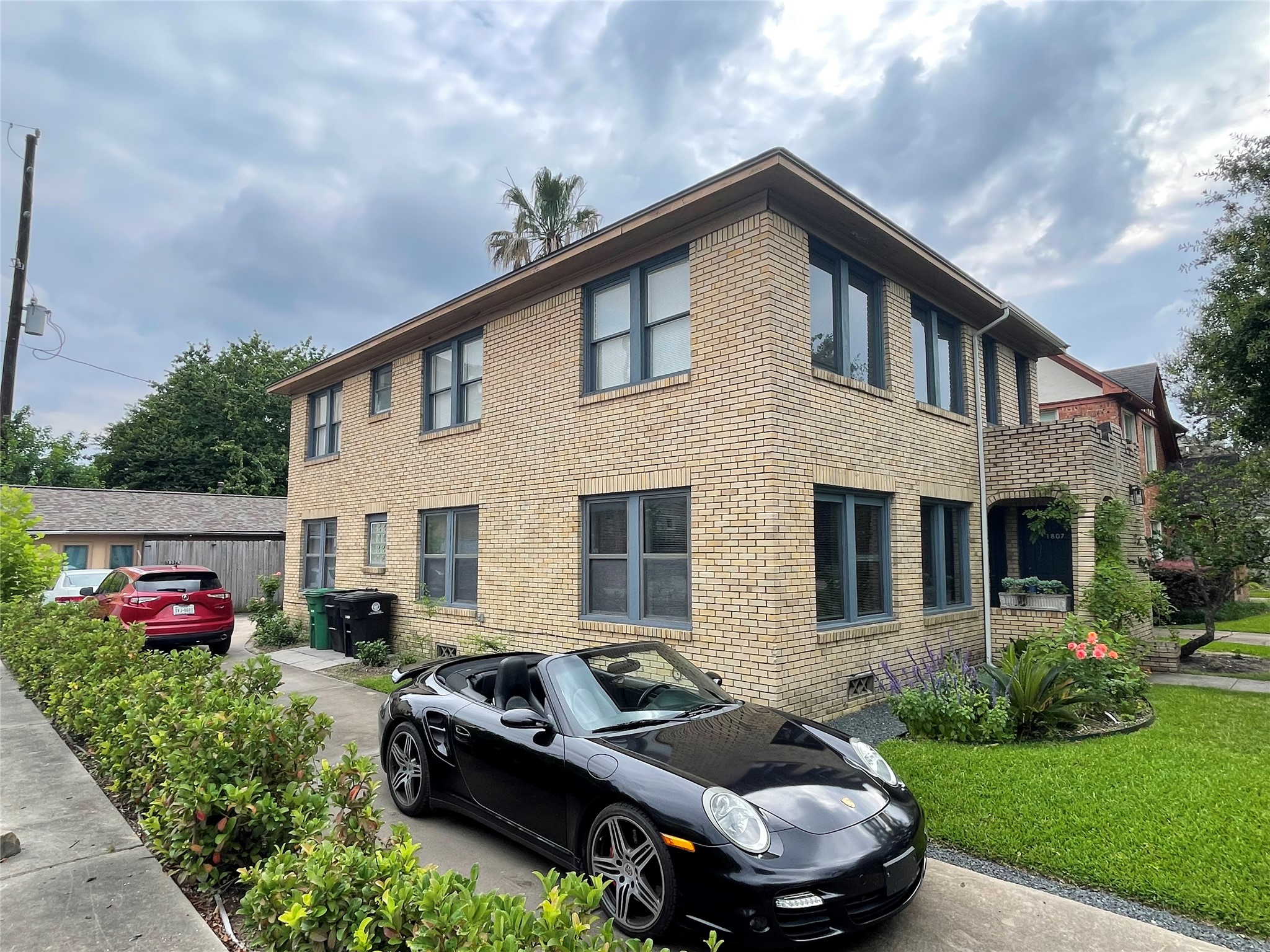 a front view of house with yard and car parked
