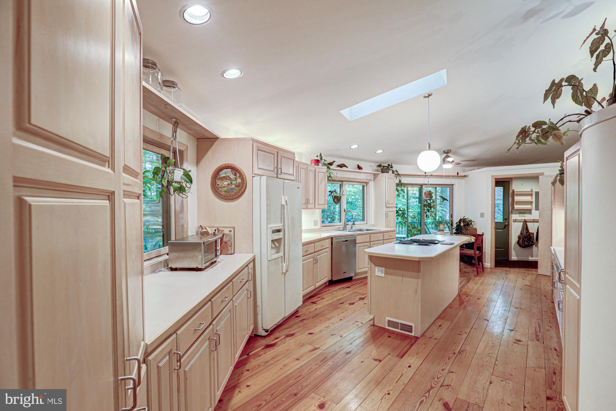 75 Good Hope Road Landenberg, PA 19350 - Photo 18 of 65 a open kitchen with stainless steel appliances granite countertop a refrigerator a sink dishwasher a stove and white countertops with wooden floor