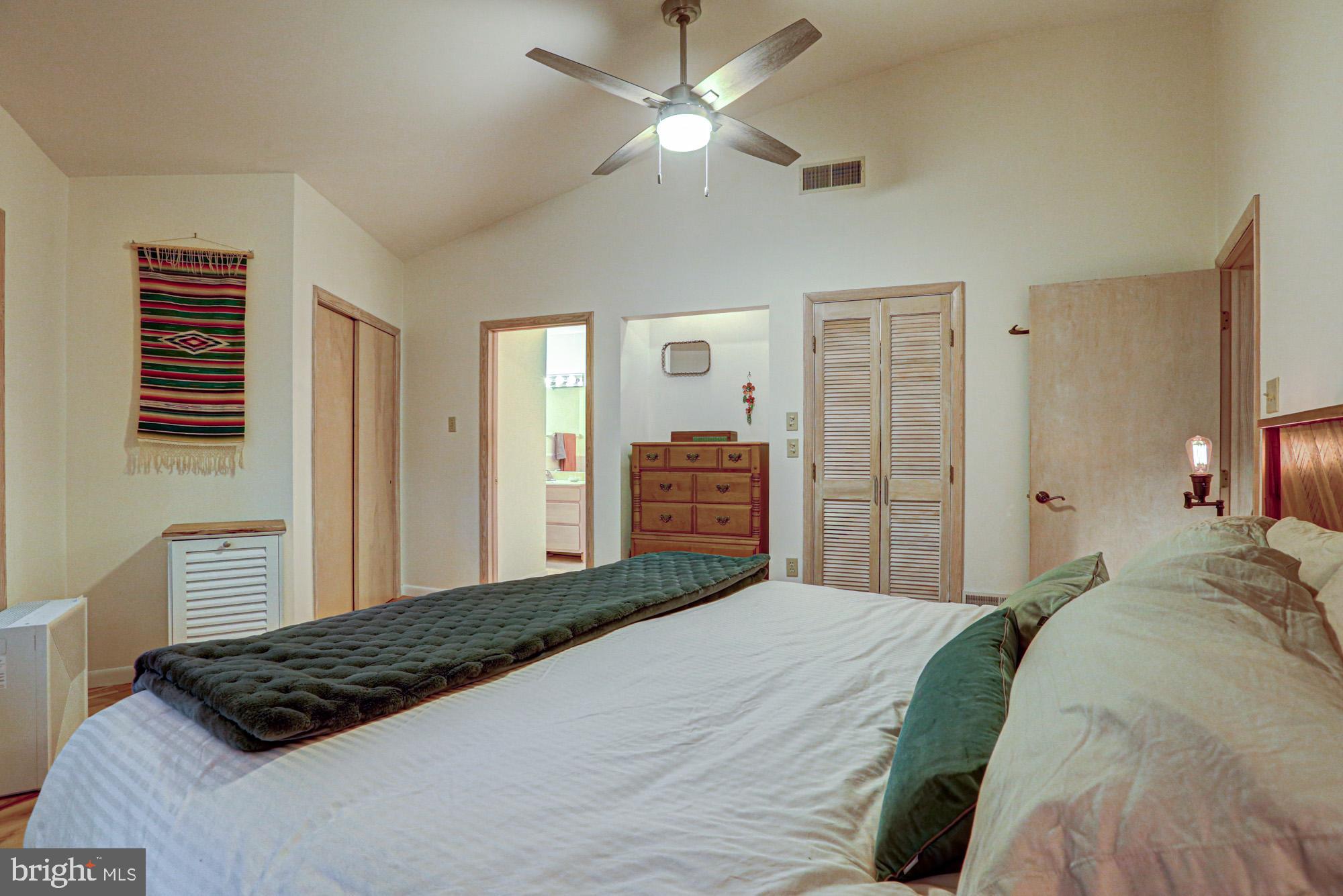 75 Good Hope Road Landenberg, PA 19350 - Photo 44 of 65 a bedroom with a large bed and a chandelier