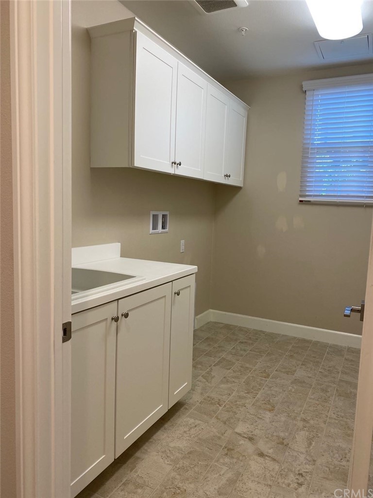 63 Singer Irvine, CA 92620 - Photo 14 of 33 a view of cabinets and utility room with window
