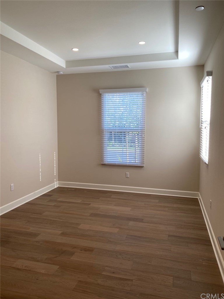 63 Singer Irvine, CA 92620 - Photo 2 of 33 an empty room with wooden floor and windows