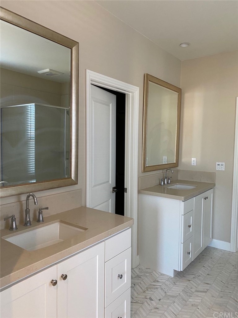 63 Singer Irvine, CA 92620 - Photo 21 of 33 a bathroom with a granite countertop sink and a mirror