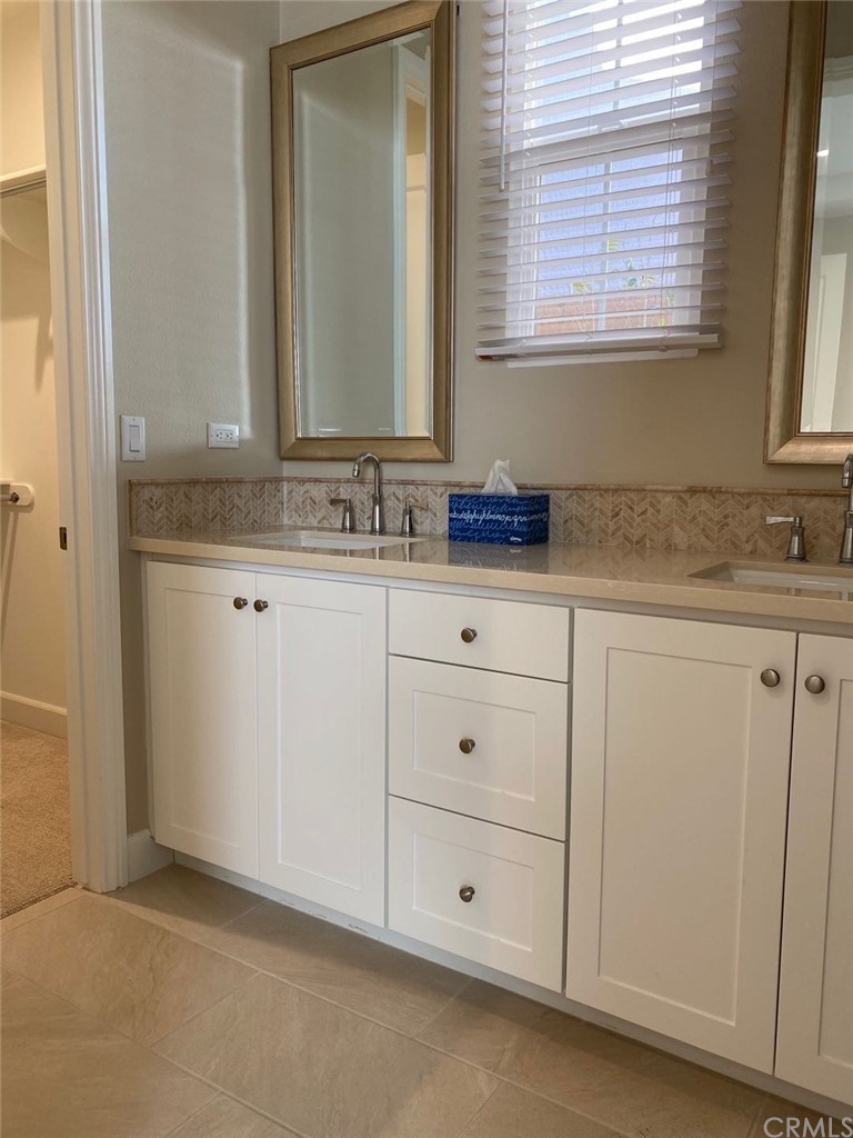 63 Singer Irvine, CA 92620 - Photo 3 of 33 a bathroom with a granite countertop sink and a mirror