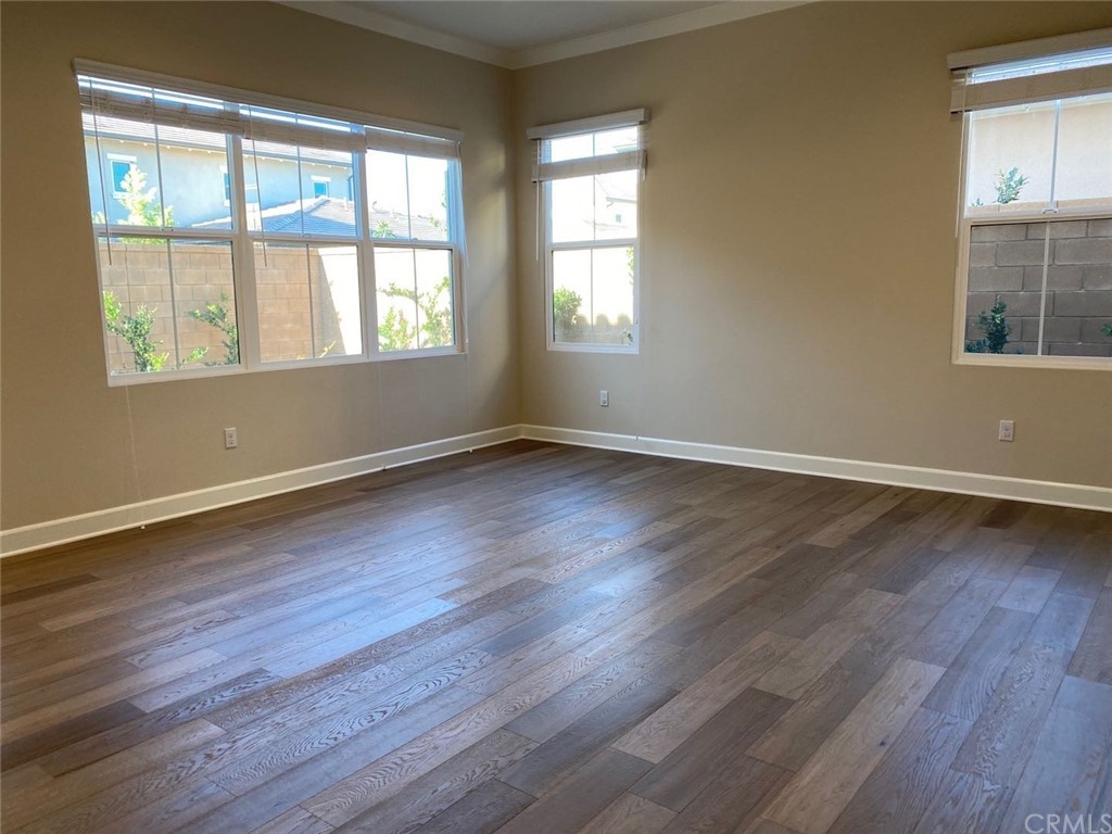 63 Singer Irvine, CA 92620 - Photo 7 of 33 a view of an empty room with wooden floor and a window