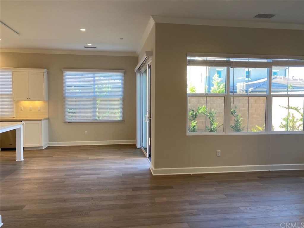 63 Singer Irvine, CA 92620 - Photo 8 of 33 an empty room with wooden floor and windows