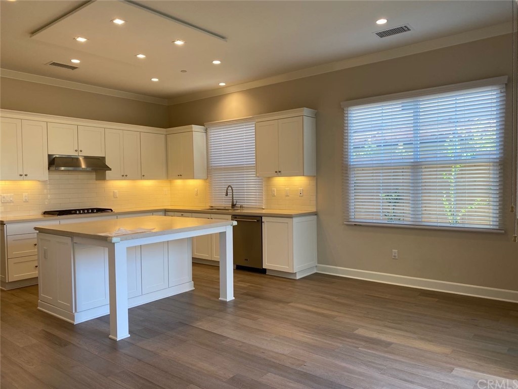 63 Singer Irvine, CA 92620 - Photo 9 of 33 a kitchen with stainless steel appliances granite countertop a sink a stove a refrigerator and a microwave