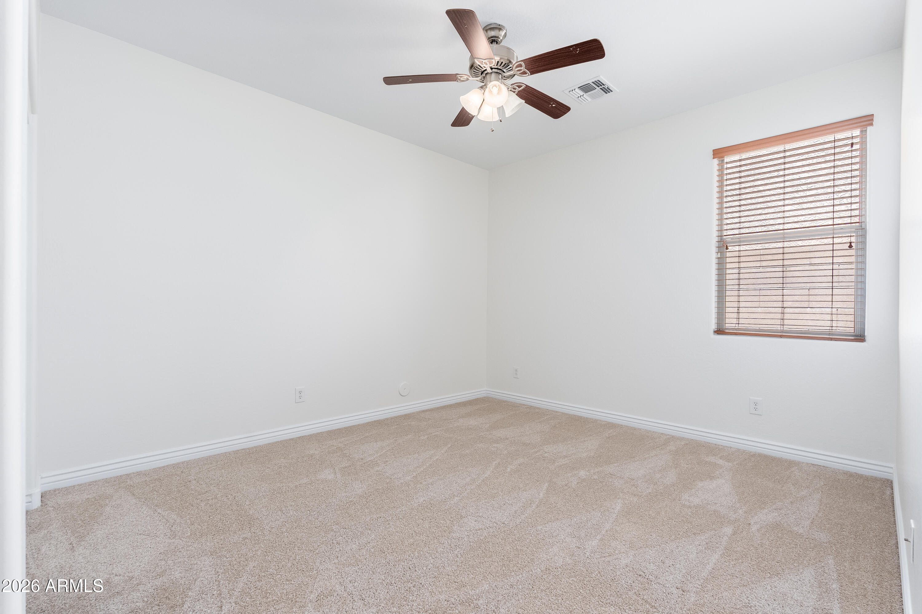 4317 East Folgers Road Phoenix, AZ 85050 - Photo 18 of 40 an empty room with a window and a fan