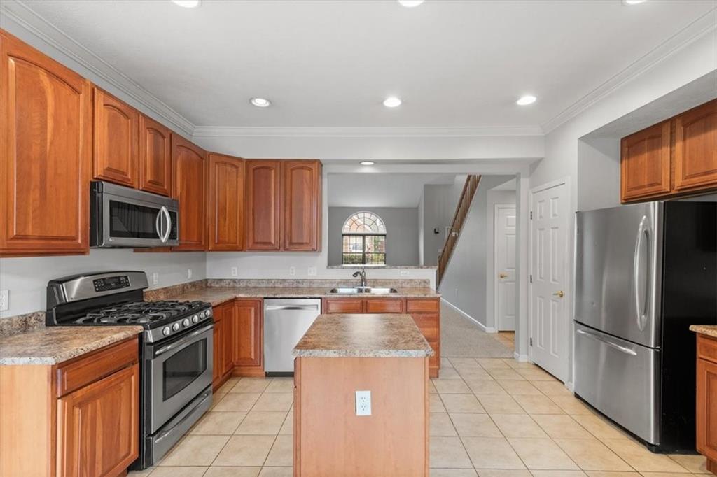 125 Park Place McKees Rocks, PA 15136 - Photo 8 of 44 a kitchen with stainless steel appliances granite countertop a stove a sink dishwasher a refrigerator and cabinets with wooden floor
