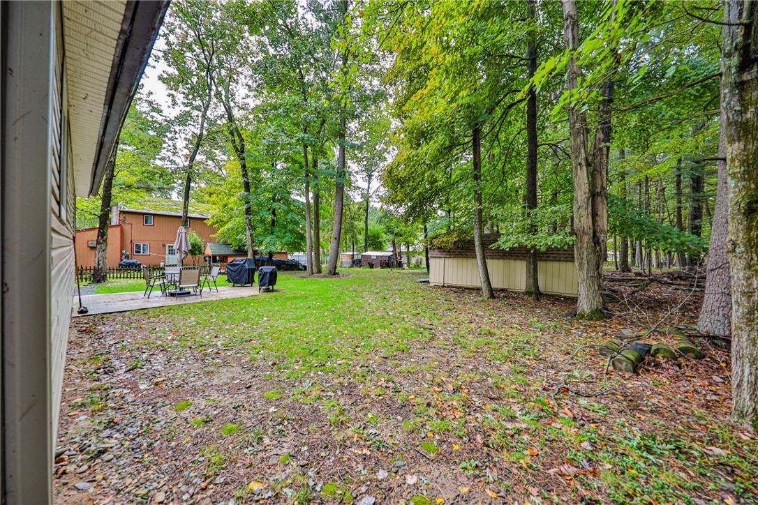 24 Turkey Ridge Road East Stroudsburg, PA 18302 - Photo 28 of 34 Mature trees frame a peaceful outdoor space complete with a patio and storage shed.