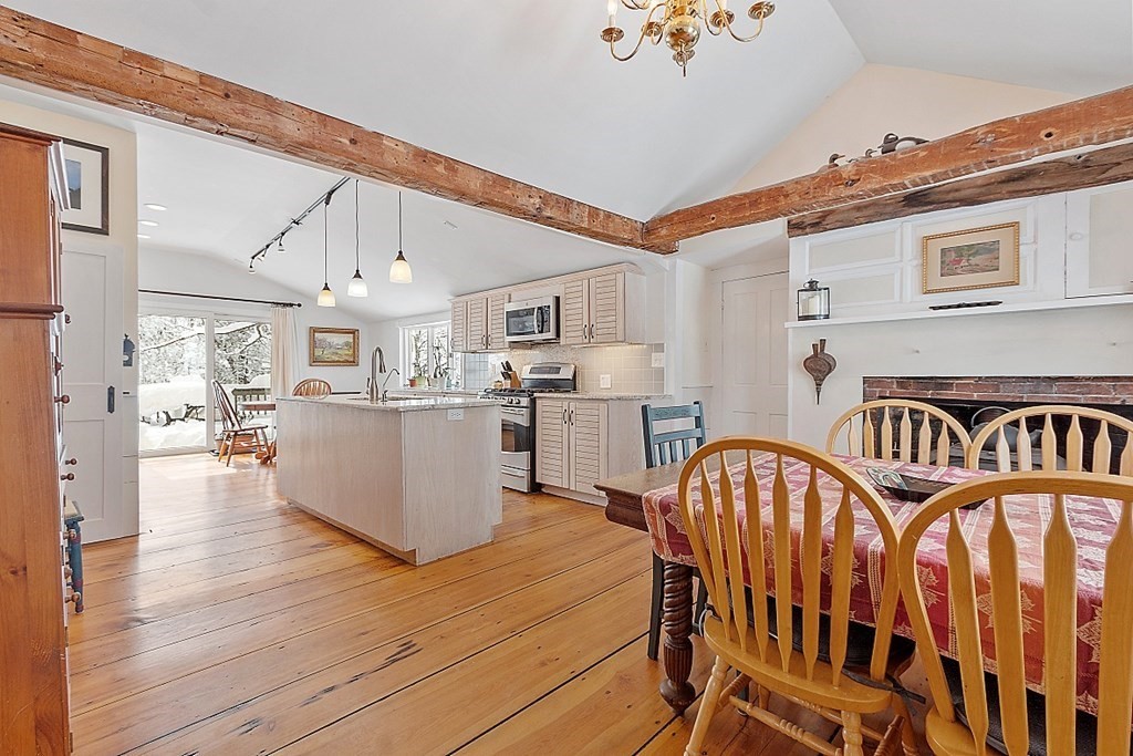 4 Hardwick Road Petersham, MA 01366 - Photo 3 of 42 a kitchen with stainless steel appliances kitchen island granite countertop a table chairs in it and wooden floors