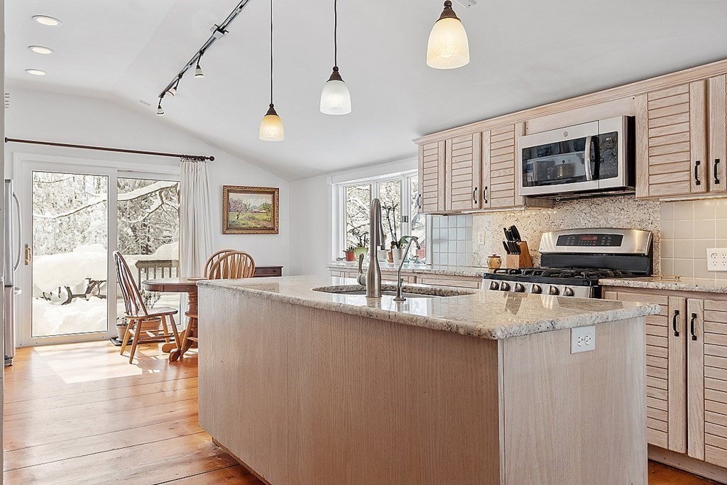 4 Hardwick Road Petersham, MA 01366 - Photo 5 of 42 a kitchen with stainless steel appliances granite countertop a sink dishwasher a stove top oven a dining table and chairs with wooden floor