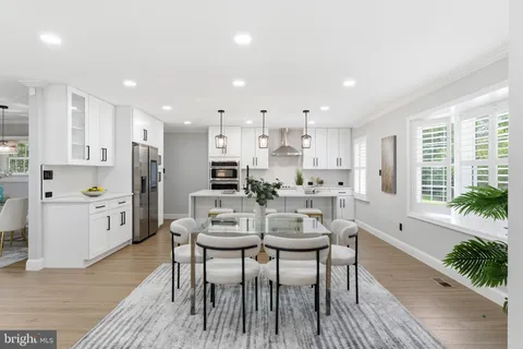 a view of kitchen with refrigerator dining table and chairs