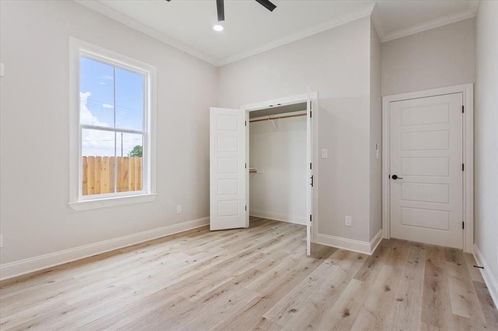 107 North Jena Street Riesel, TX 76682 - Photo 23 of 34 an empty room with wooden floor and windows