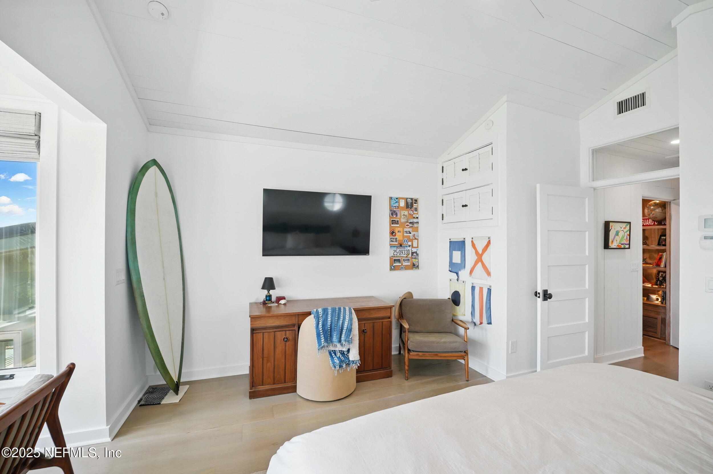 816 Ocean Front Neptune Beach, FL 32266 - Photo 28 of 65 a bedroom with furniture and a flat screen tv