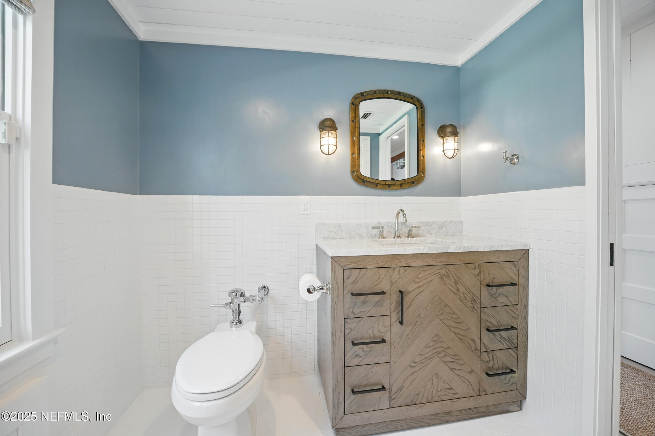816 Ocean Front Neptune Beach, FL 32266 - Photo 37 of 65 a bathroom with a toilet a sink and mirror