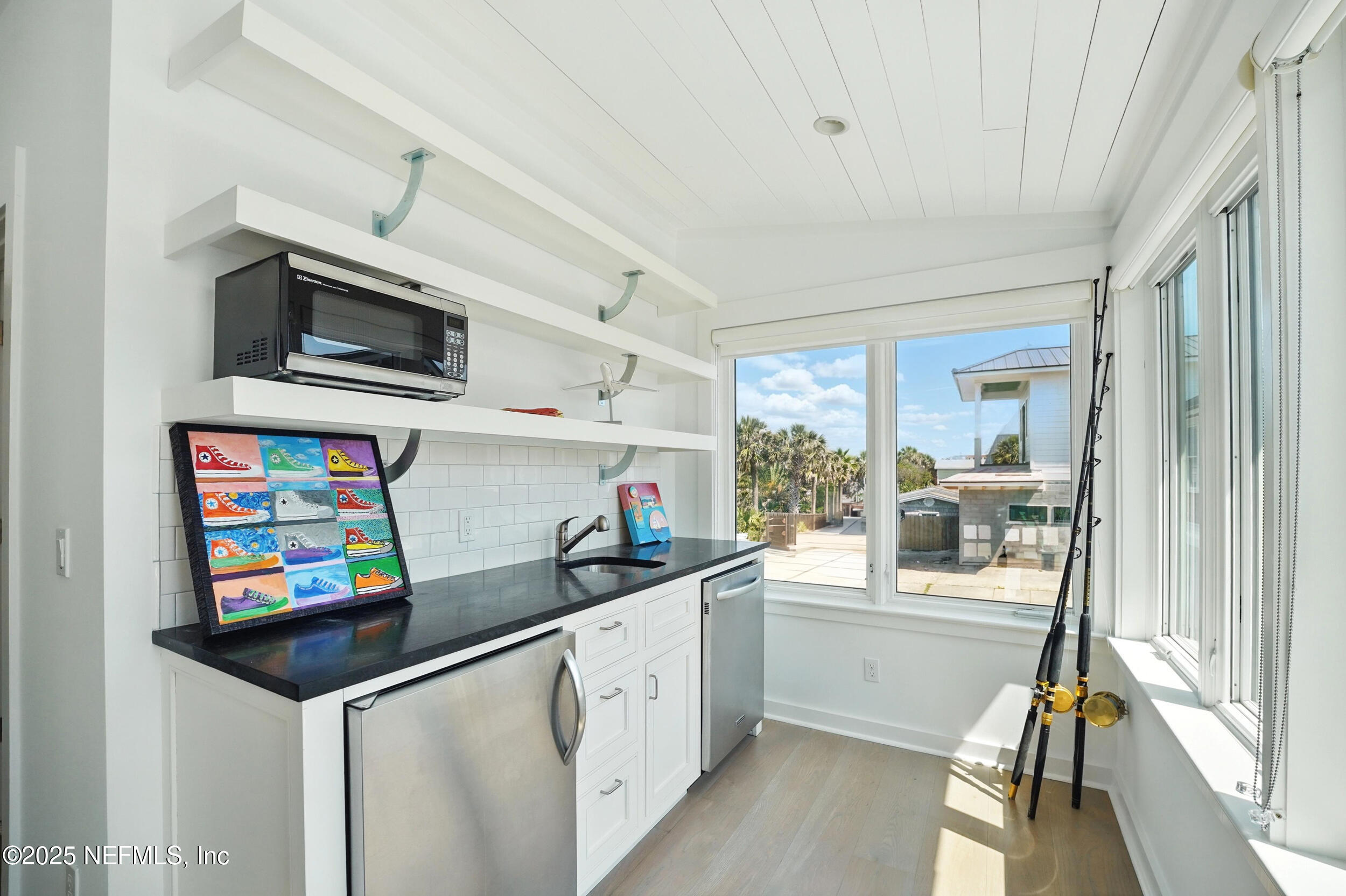 816 Ocean Front Neptune Beach, FL 32266 - Photo 45 of 65 a kitchen with granite countertop a sink cabinets and stainless steel appliances