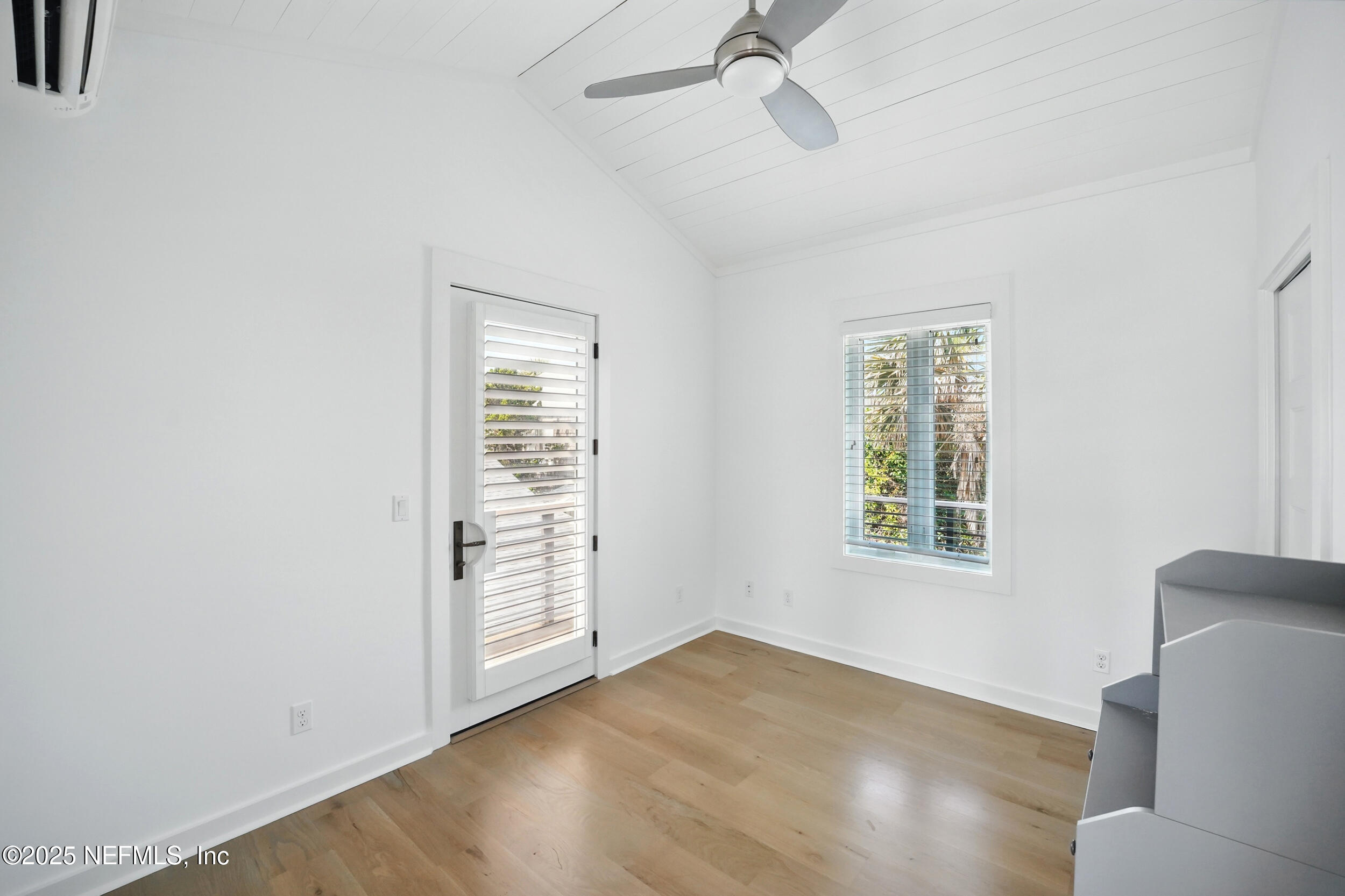 816 Ocean Front Neptune Beach, FL 32266 - Photo 47 of 65 a view of an empty room with a window and wooden floor