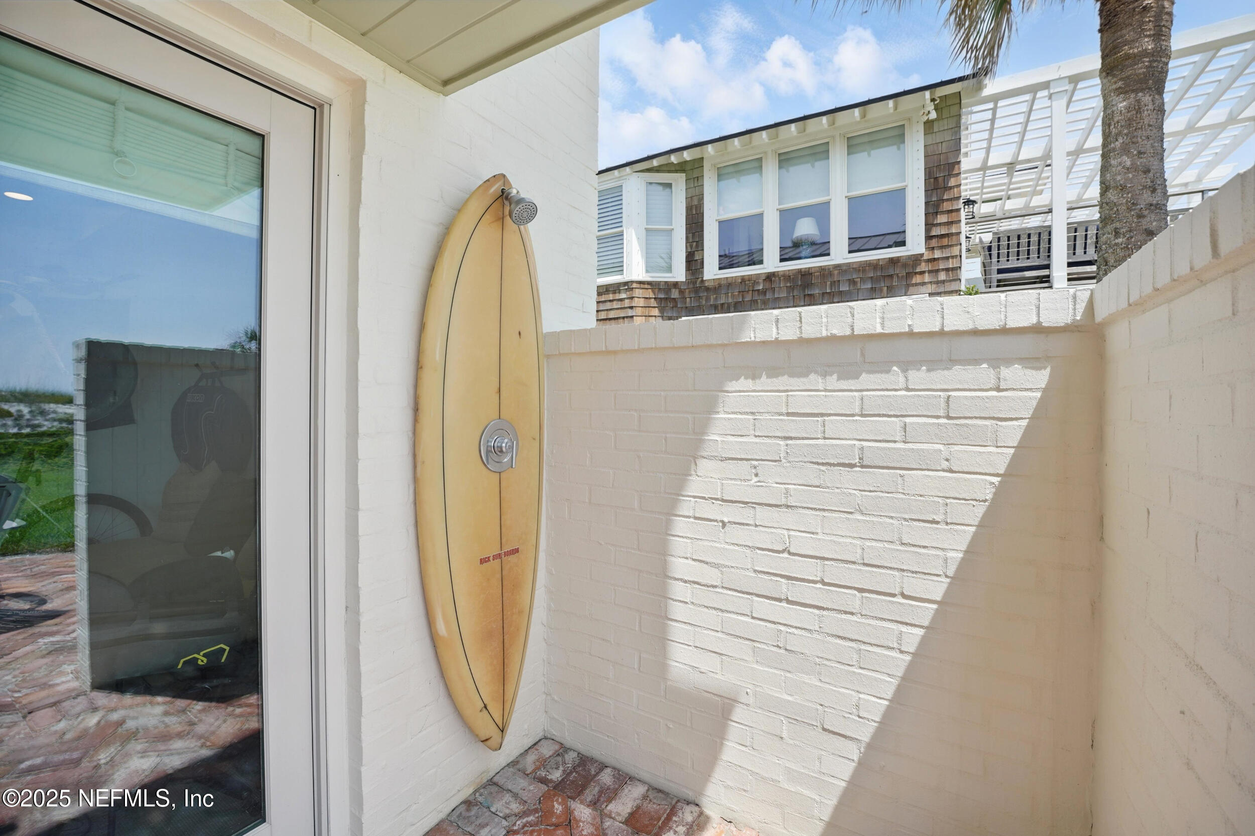 816 Ocean Front Neptune Beach, FL 32266 - Photo 49 of 65 a view of a brick house with a door