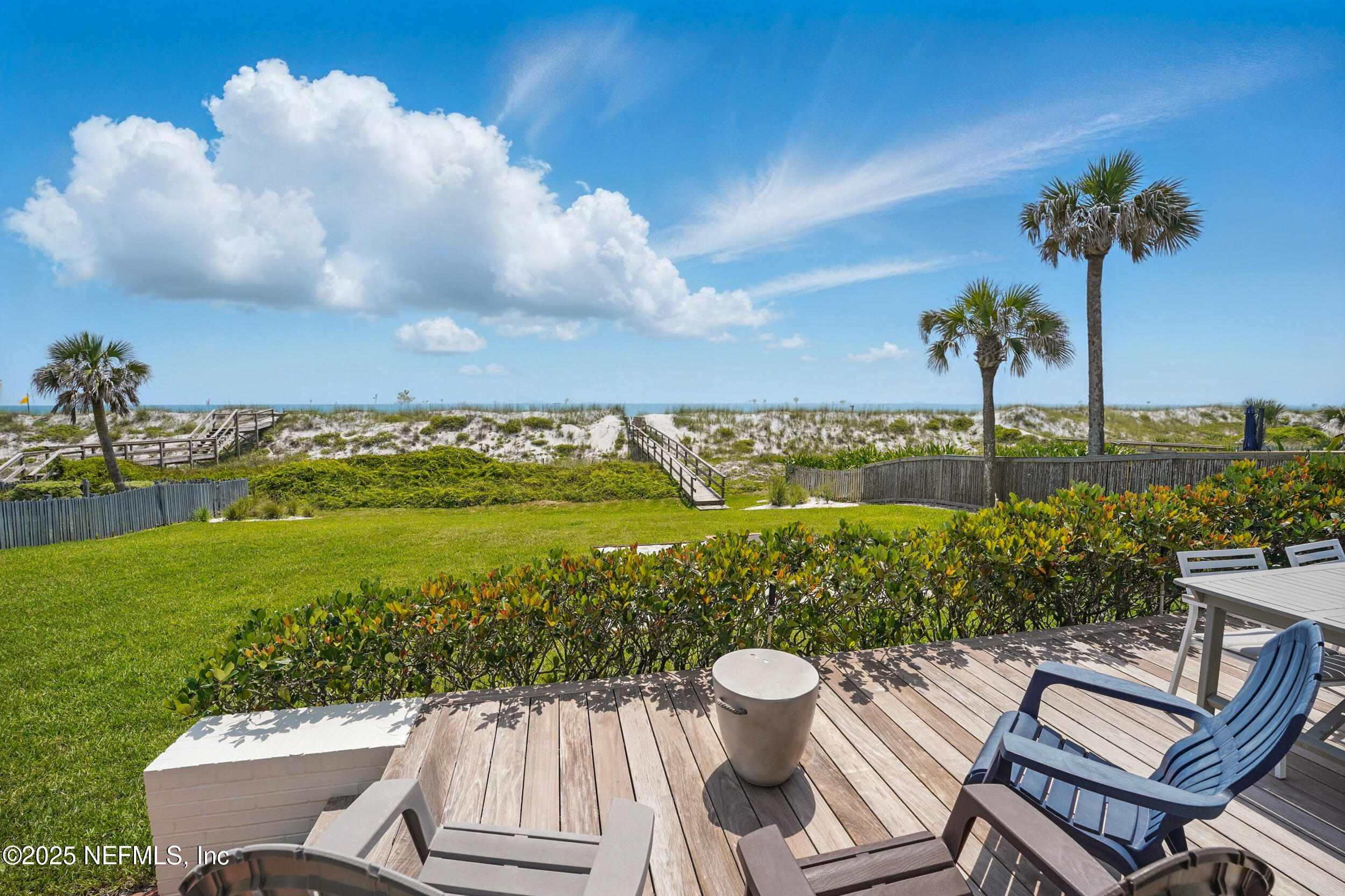 816 Ocean Front Neptune Beach, FL 32266 - Photo 50 of 65 a view of a swimming pool and lounge chairs in back yard of the house